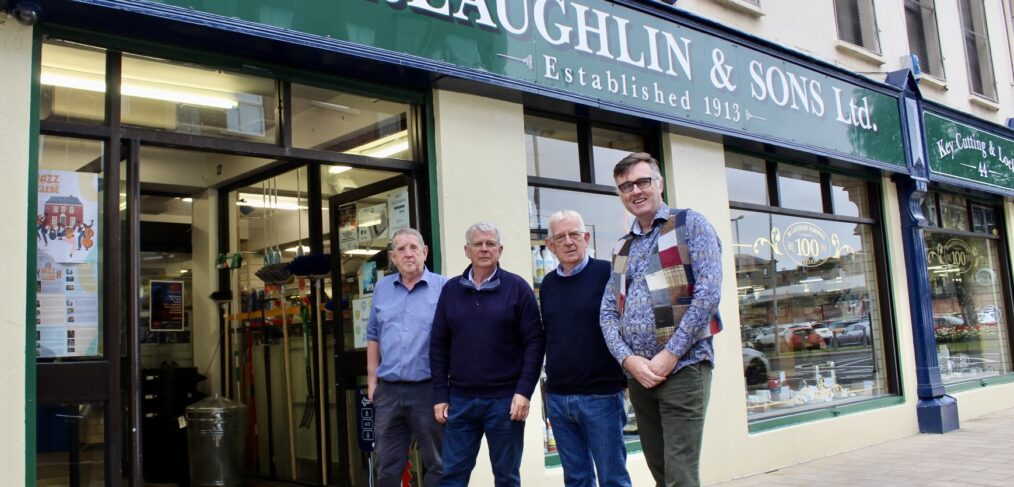 The McLaughlin Brother with Mark Patterson outside the shop front
