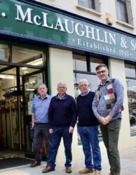 The McLaughlin Brother with Mark Patterson outside the shop front